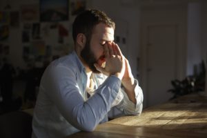 young man sitting at kitchen table with hands on f 2022 03 08 00 13 28 utc 1