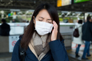 woman with face mask and feeling headache 2022 12 15 21 00 14 utc 1